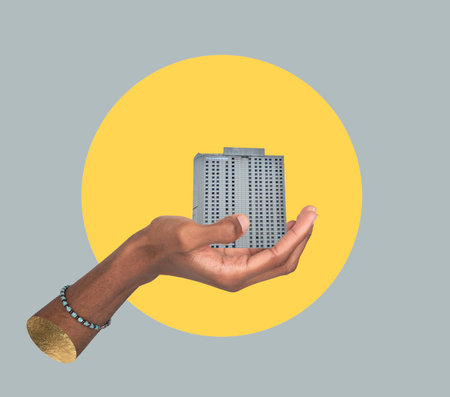 Building in hand concept. African male holding modern high rise and apartment collage, showing real estate development, urban architecture, commercial property and housing project promotion inの写真素材