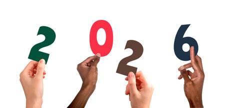 2026 new year celebration. Diverse multiethnic team raising colorful hands with numbers and letters, festive winter concept of happiness, business greeting and party card. Isolated on white backgroundの写真素材