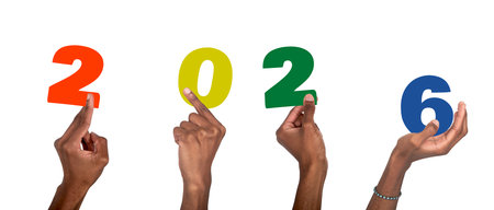 2026 new year celebration. Dark-skinned male hand raised with colorful numbers symbolizing festive...