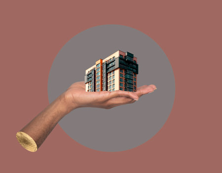 Building in hand vision of growth. African American male holding modern high rise apartment collage, showing urban architecture, real estate ownership, investment promotion and creative businessの写真素材