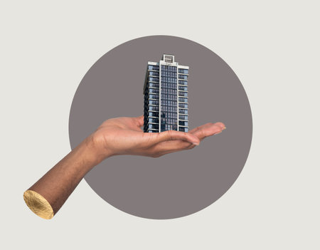 Building in hand creative concept. African American male holding modern high rise apartment collage, showing real estate investment, urban architecture, corporate property development and businessの写真素材