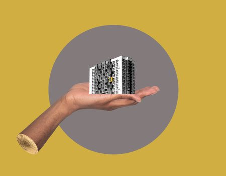 Building in hand investment concept. African American male holding modern high rise apartment collage, showing real estate development, urban architecture, residential property ownership and creativeの写真素材
