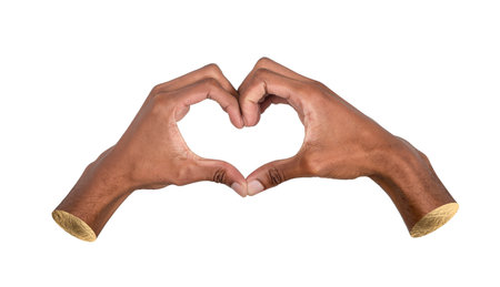 Hand forming heart shape gesture, symbol of love, care, friendship and unity, positive sign of kindness and affection isolated on white background.の写真素材