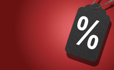 Black Friday sale banner. Black tag with red gradient design and hanging loop, symbol of discount, price off, and special offer, minimalist autumn style for retail, fashion, and business marketingの写真素材