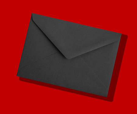 Black envelope with a letter inside. Premium stationery for mail, invitation, correspondence, or office use. Concept design for VIP, luxury, or business communication.の写真素材