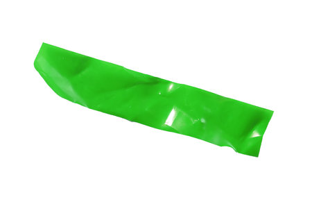 Bright green adhesive tape piece with irregular edges and visible folds, isolated on white. Wrinkled glossy surface texture for modern graphic layouts. for scrapbooking, collageの写真素材