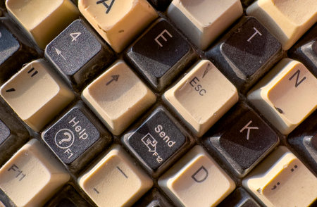Close up view of a vintage computer keyboard with worn keys and visible signs of use. Retro...