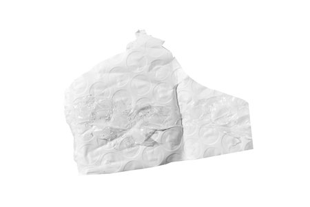Torn bubble wrap piece with circular cells and creases isolated on white. Wrinkled plastic fragment...