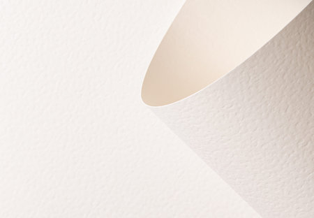 Warm beige textured paper background with curved folded edge and airy depth. Matte surface with...
