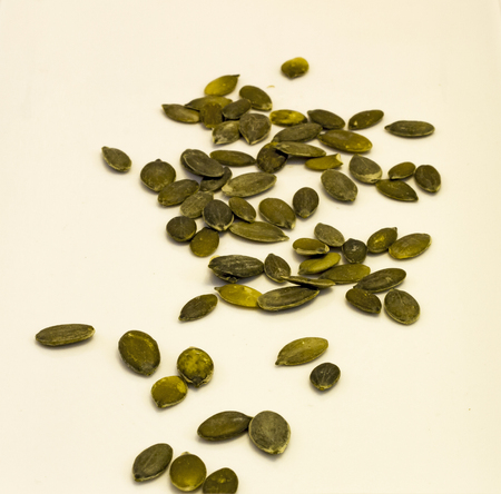 Photo peeled pumpkin seeds, isolated on a white background.の写真素材