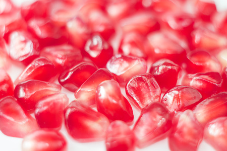 Beautiful photos of grains cut pomegranate on a white backgroundの写真素材