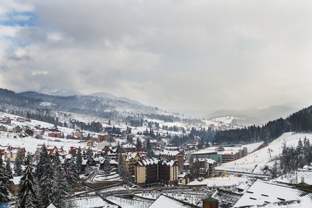 Skiers and snowboarders enjoying on slopes of ski resort Bukovel, Ukraine.の写真素材
