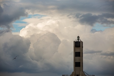 Tower lighthouse on the background of a winter storm sky .の写真素材