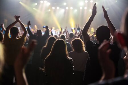 Crowd at concert and blurred stage lights . Close up of photographing with smartphone during a...