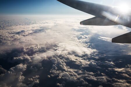 Flying and traveling, view from airplane window on the wing on sunset time .の写真素材