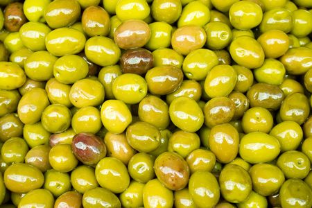 a lot of green olives with olive oilの写真素材