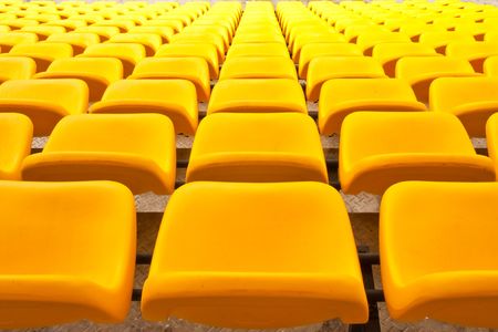 Rows of yellow seats in stadiumの写真素材