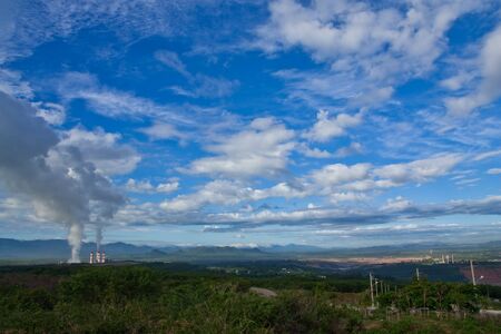 Smoke from electric plant and blue skyの写真素材