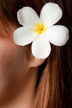 Tropical flower on girl's hairの写真素材