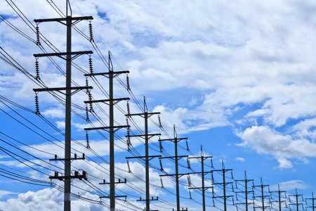 Electric pylons and blue skyの写真素材