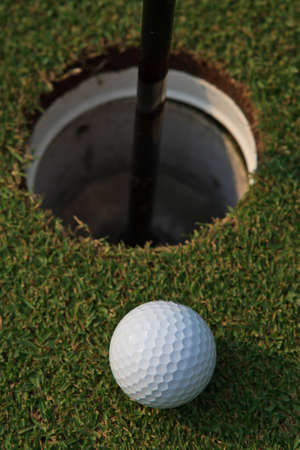 Golf ball near holeの写真素材