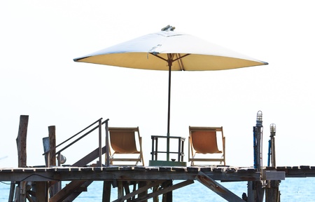 White umbrella and beach chairの写真素材