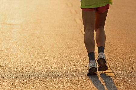 Runner running in the light of eveningの写真素材