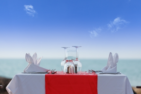 Luxury dinner table on beach in blue skyの写真素材