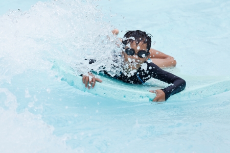 Young boy playing in clear water