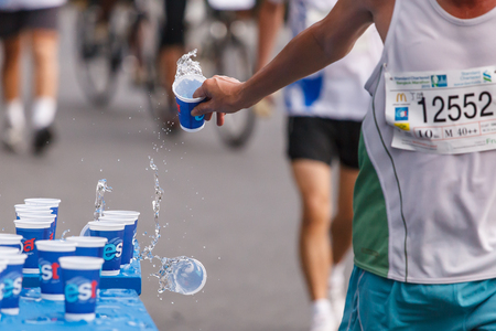 BANGKOK, THAILAND - NOVEMBER 17 : Unidentified runner catching up water during Standard Charterd Bangkok Marathon 2013 running championship on November 17, 2013 in Bangkok, Thailand.のeditorial素材