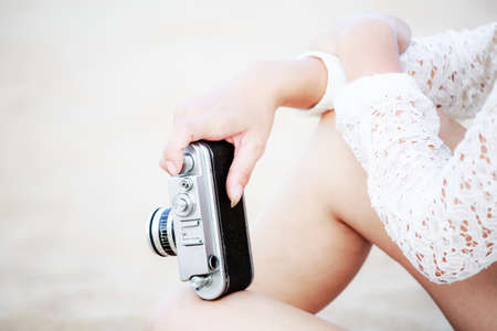 Woman handling old camera in vintage styleの写真素材