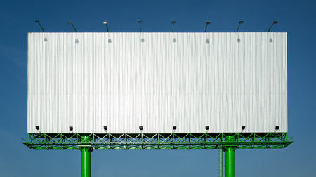 Huge blank new advertising billboard in blue skyの写真素材