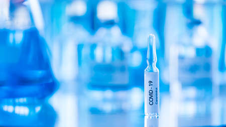 Bottle of COVOD-19 vaccine sample in a laboratory. Idea for researching and lab tests for...