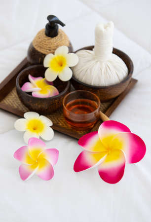 Set of spa treatments, natural oil, and plumeria flowers.の写真素材