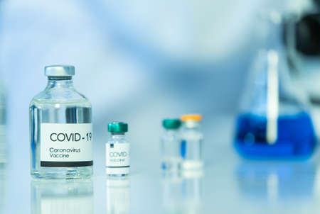 Bottle of COVOD-19 vaccine sample in a laboratory. Idea for researching and lab tests for coronavirus curing.の写真素材