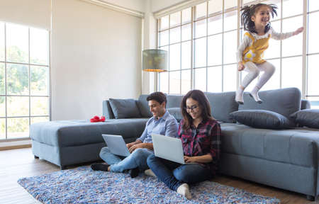 Three members of diverse family, Caucasian father, Asian mother and little half daughter spend time...