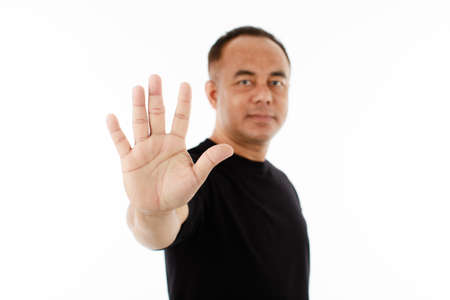 Portrait of  middle age senior Asian man in a black t-shirt showing his five fingers for number 5 or...