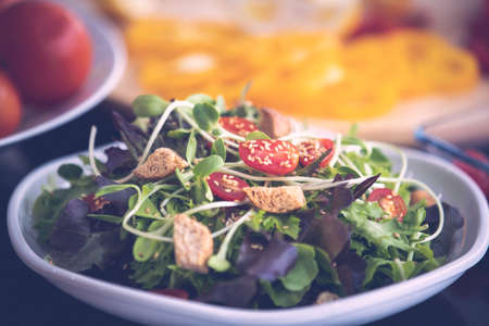Mix vegetables and crunchy bread salad preparing ready to serve, vegan green food for good health care and diet. Homemade dietary menu for daily life.の写真素材