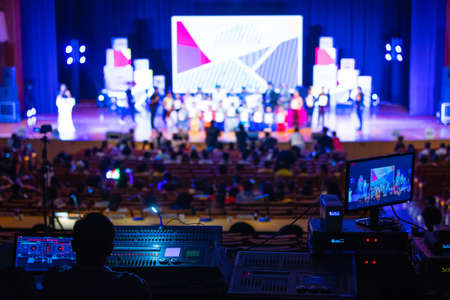 Blur image of sound engineer team working to prepare for music concert stage. Backstage crew event...