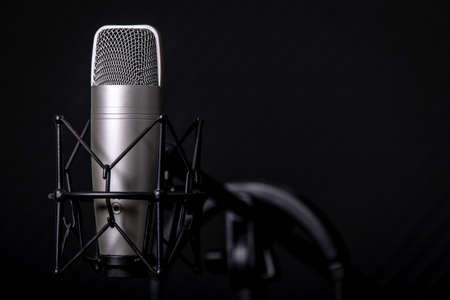 Sound and voice recording studio with nobody. Vintage style microphone and tools for record in room with noise reduction and resonance absorb foam wall in background for good acoustic with copy space.の写真素材