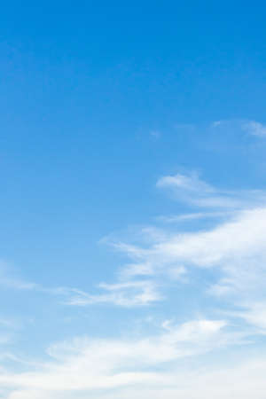 Blue sky nature clear view with white clouds and copyspace on top left.の写真素材