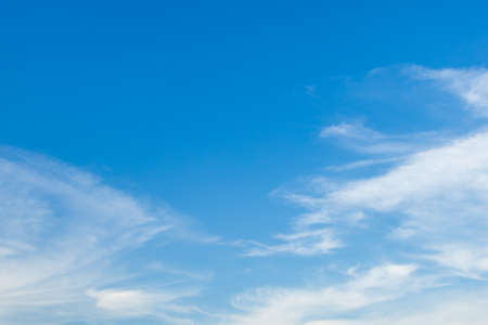 Blue sky nature clear view with white clouds and copyspace on top left.の写真素材