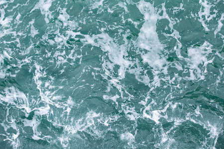Sea water with white foam on surface, taken form top view angle.の写真素材