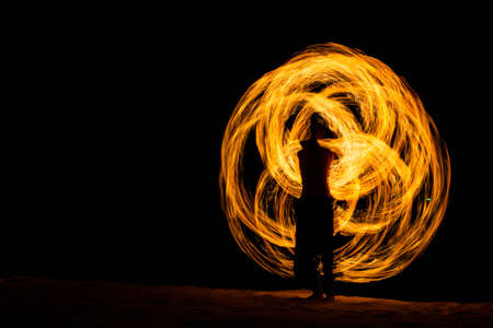 Fire playing show on beach of island in Thailand.の写真素材