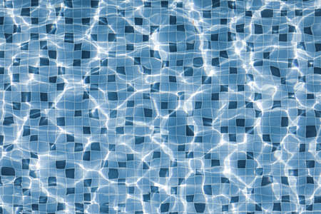 Texture of water surface in swimming pool look transparent to tiles on the floor.の写真素材