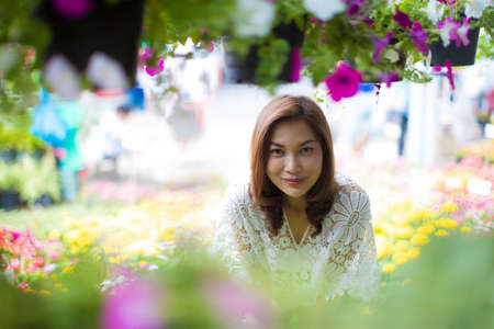 Beautiful Asian woman selecting flower in floral shop, lifestyle of modern housewife.の写真素材