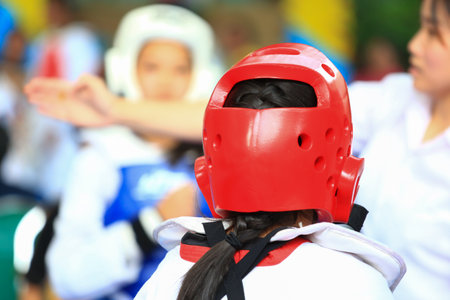 Referree gives signal to girls during Taekwondo figting contestの写真素材