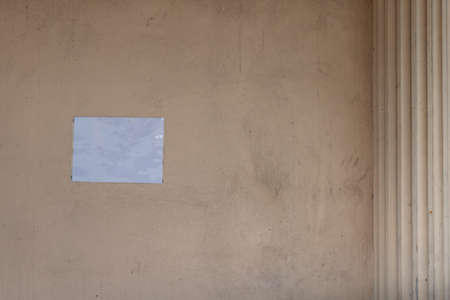 Blank white paper for banner sticked on old and dirty concrete wall.の写真素材
