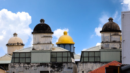 Group of four top domes on colorful old traditional mosque with blue sky and white soft clouds in background. Concept of religious place and building style.の写真素材