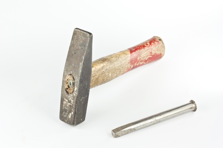 Old hammer and nail isolated on white background